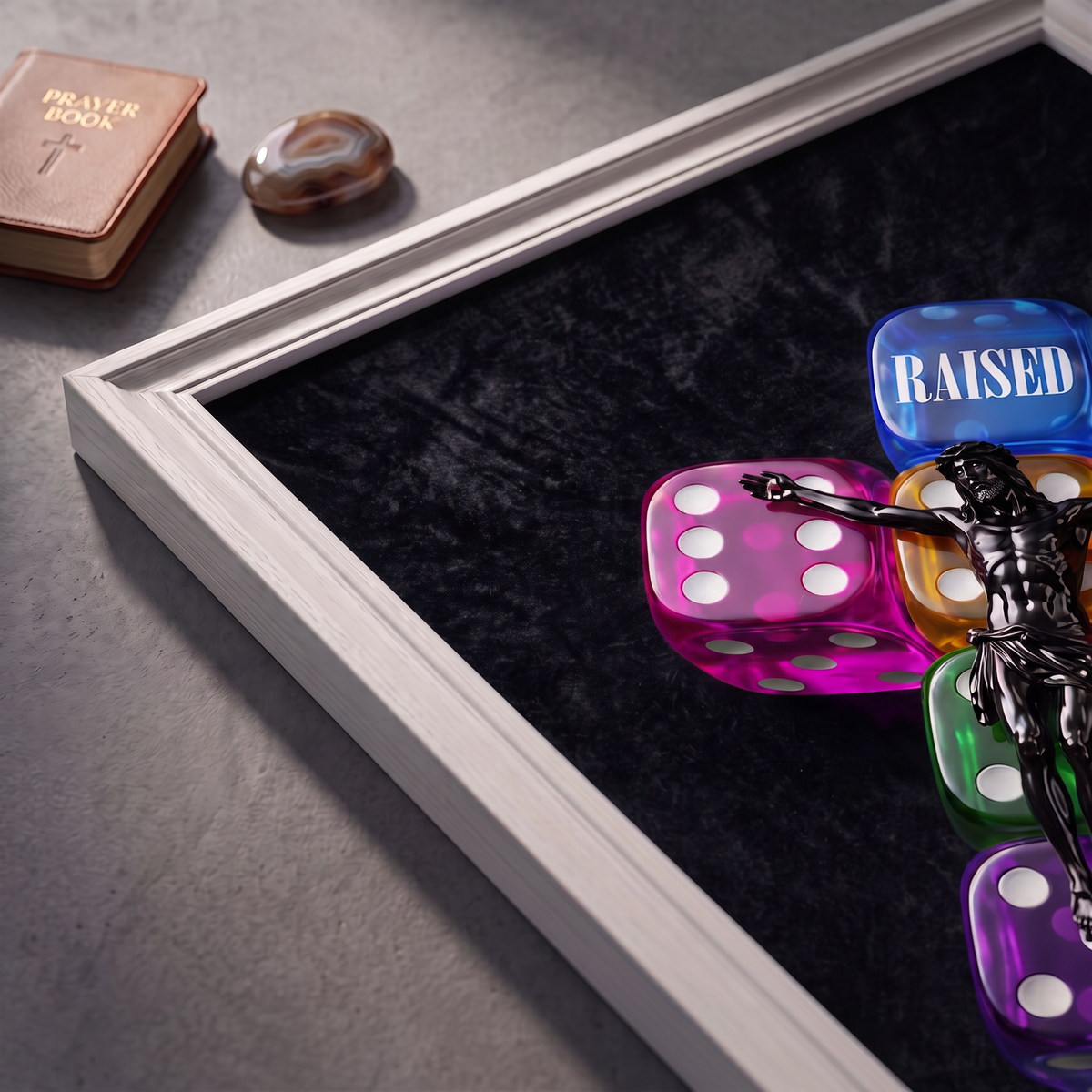 Angled close-up of the RAISED black poster showing Jesus over colorful dice and RAISED lettering.