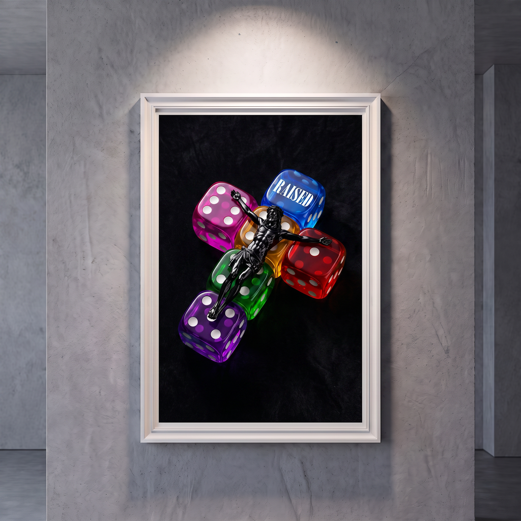 RAISED black Jesus poster featuring colorful translucent dice, displayed in a white frame on a gray wall.