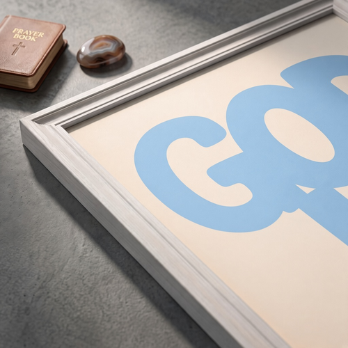 Angled close-up of the God Is Good blue poster showing rounded lettering on a cream background.