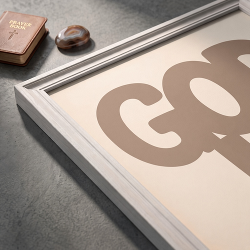 Angled close-up of the God Is Good brown poster showing rounded lettering on a cream background.