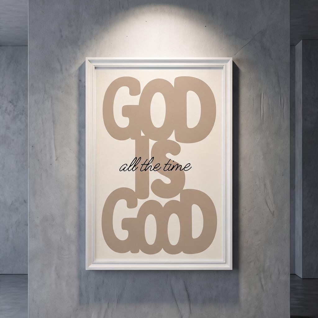 God Is Good brown typography poster on cream, displayed in a white frame against a gray wall.