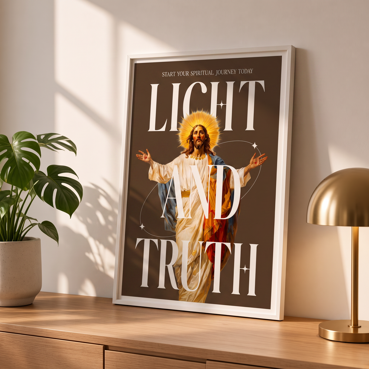 Light & Truth brown Jesus poster in a styled tabletop mockup beside a plant and a brass-colored lamp.