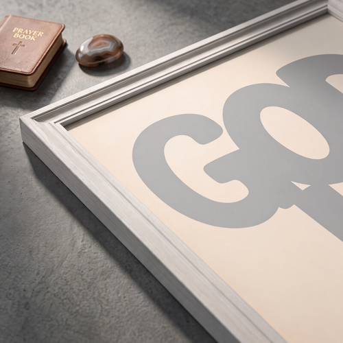 Angled close-up of the God Is Good grey poster showing rounded lettering on a cream background.